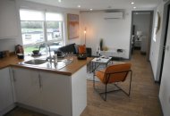 Housing unit view from kitchen into lounge area.