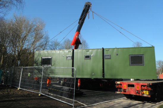 container housing module lifted by a crane side view