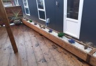 Front door and trough planters of container houseboat