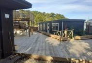 Front view of container houseboat and surrounding decking