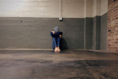 Woman sitting on the floor in an empty room