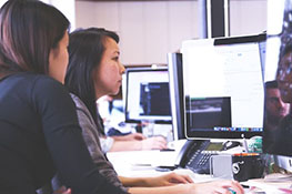 Two women looking at a computer monitor