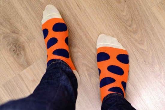 feet in spotted socks on wood effect laminate flooring
