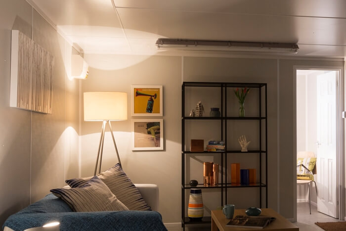 Internal view of lounge area of container building and door leading to another room