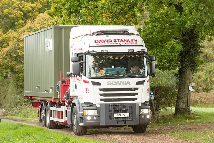 Lorry with container housing unit on the back